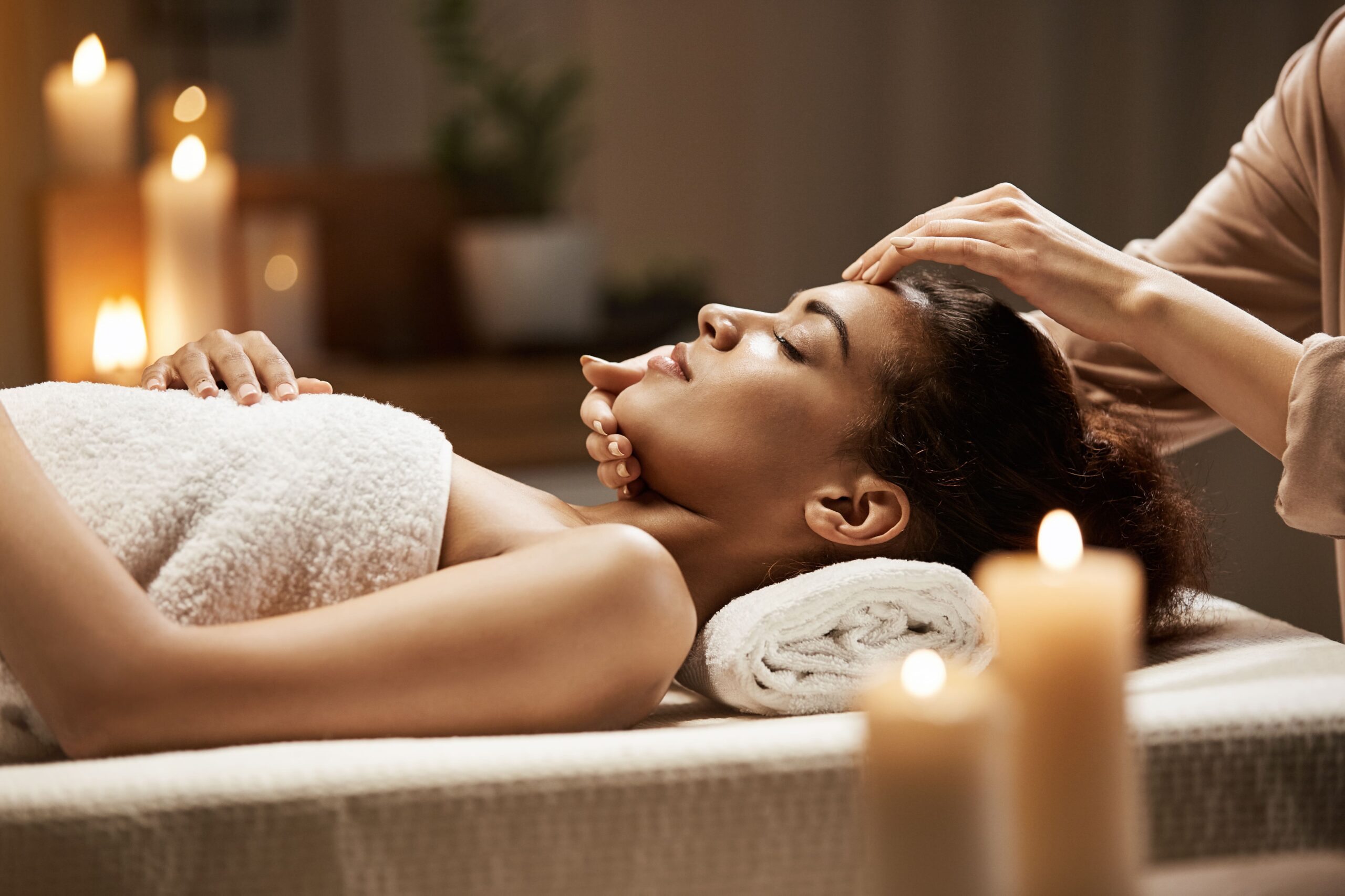 attractive-african-woman-enjoying-face-massage-spa-salon-2